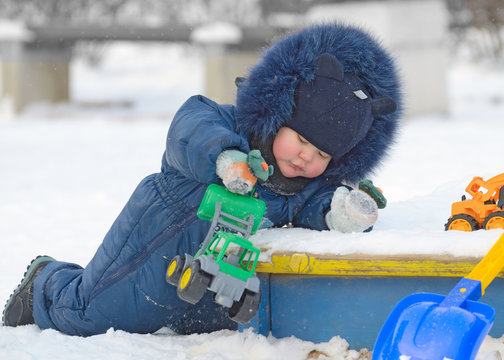A small child plays on the Playground.