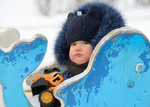 A small child plays on the Playground.