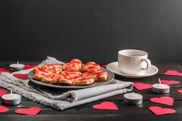 Obraz na płótnie Canvas cookie-hearts, paper hearts, candles, boxes with presents and a Cup of black coffee, congratulation with Valentine's day.