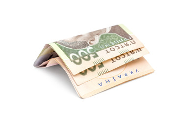 Folded five hundred hryvnia bills on white background.
