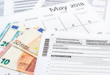 German tax form with money and calendar. 