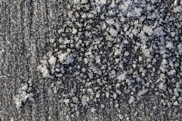 Beautiful frost crystals on wood close-up texture background