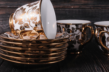 golden tea set on a black background
