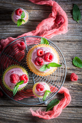 Raspberry cupcake made of pink cream and fresh fruits