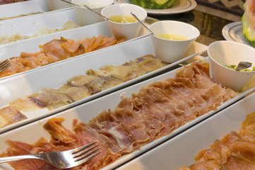 fish and meat plates on a buffet