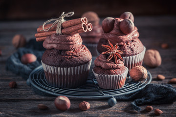 Sweet cupcake made of brown cream, nuts and chocolate