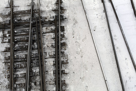 Winter top view on railway tracks and switch in snow background