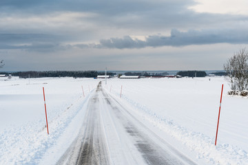 Country road with snow stakes