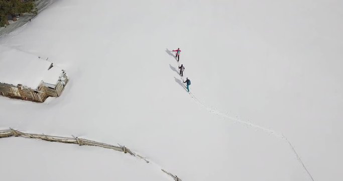 Look-up shot on some ski-touring men and mountains.