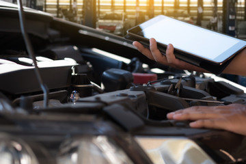 Obraz premium Mechanic repairing a car in garage Auto repair car engine, close u