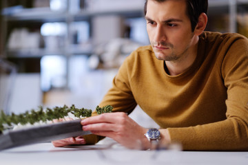 Man working with maquette in design and engineering architecture office