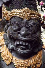 Fototapeta na wymiar Traditional Balinese stone demon sculpture at Bali, Indonesia.