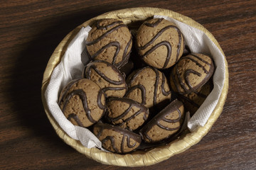 Chocolate oatmeal cookies in a wicker basket.