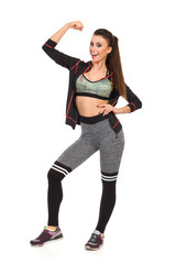 Laughing Fit Young Woman Is Rising Arm And Flexing Muscle