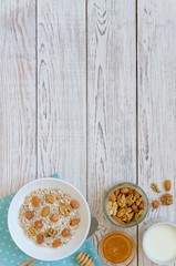 Healthy breakfast of muesli with nuts, honey and milk