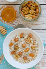 Healthy breakfast of muesli with nuts, honey and milk