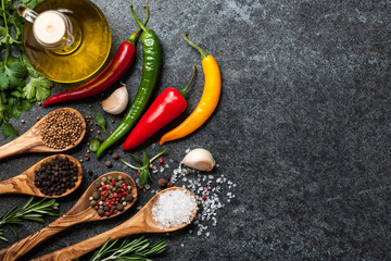 Cooking table with spices, colorful peppers and herbs