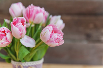 Bouquet of pink tulips over shabby wooden table. Spring greeting card happy mother day copy space