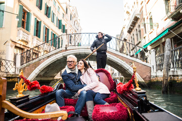 Fototapeta na wymiar Couple sailing on venetian gondola
