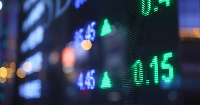Stock market data showing growth on screen