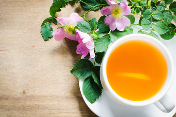 Cup of morning tea with lemon and delicate flowers