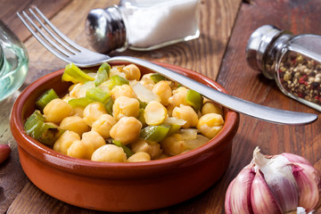 casserole of homemade stewed chickpeas on rustic board