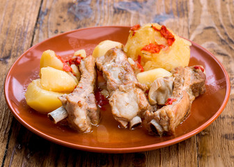 Homemade pork rib stew with potatoes on wooden board
