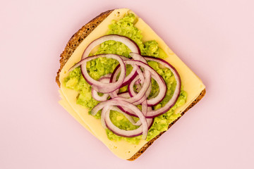 Vegetarian Avocado and Jarisberg Cheese Rye Bread Open Faced Sandwich With Sliced Onions