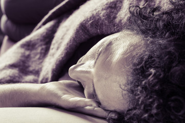 Fototapeta premium Young handsome man sleeping on sofa