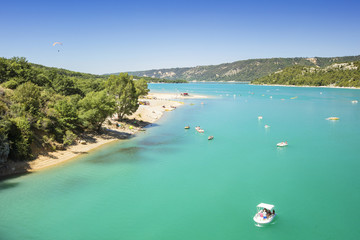 view to lake with emerald water and speedboats in cummer day in provence in France