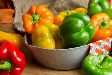 Red, green and yellow sweet bell peppers on table,