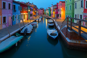 Fototapeta na wymiar Old colorful houses and boats at night in Burano, Venice Italy.