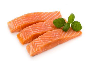 Fresh salmon fillet with basil on the white background.