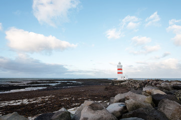 Old lighthouse in Iceland on the edge of the cliff