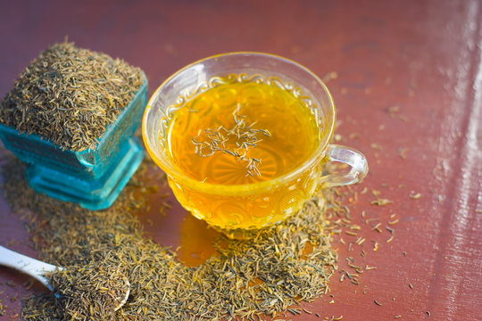 Black cumin seeds,shah jerra,Nigella sativa  and its tea on brown wooden surface.;