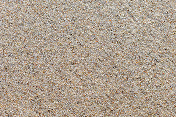surface of wet quartz sand. The background image texture.