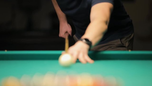 Billiards, concentrated young man playing in club