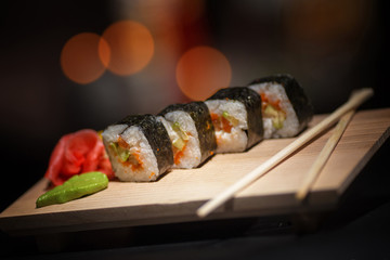 Japanese food. Appetizing sushi on a wooden board.