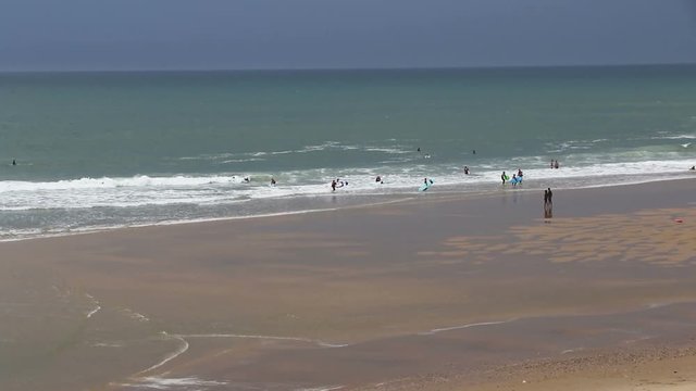 People enjoying the windy summer day at the beach in Lacanau-Ocean near Bordeaux, France
