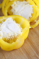 Closeup of yellow pepper slices on wooden table. Preparing food, Healthy eating.