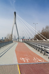 Modern suspension bridge. Warsaw in Poland. Bicycle path.
