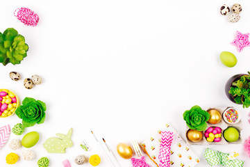 Workspace with easter decoration and bunny gift bags with candy. Spring background. Flat lay, top view