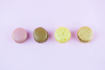 Colourful french macaroons or macaron on pink background