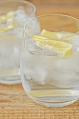 Fresh lemonade with ice and lemon on the table 
