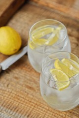 Fresh lemonade with ice and lemon on the table 