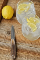 Fresh lemonade with ice and lemon on the table 