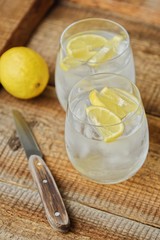 Fresh lemonade with ice and lemon on the table 