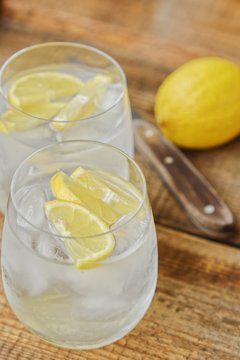 Fresh lemonade with ice and lemon on the table 