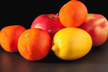 apple orange and lemon on a gray background