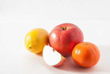 fruit, apple, lemon and orange, apple slice on a gray background